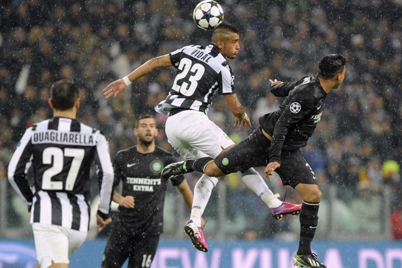 'Juventus\' Arturo Vidal (C) jumps for the ball with Celtic\'s Emilio Izaguirre during their Champions League soccer match at Juventus stadium in Turin, March 6, 2013. REUTERS/Giorgio Perottino (ITALY