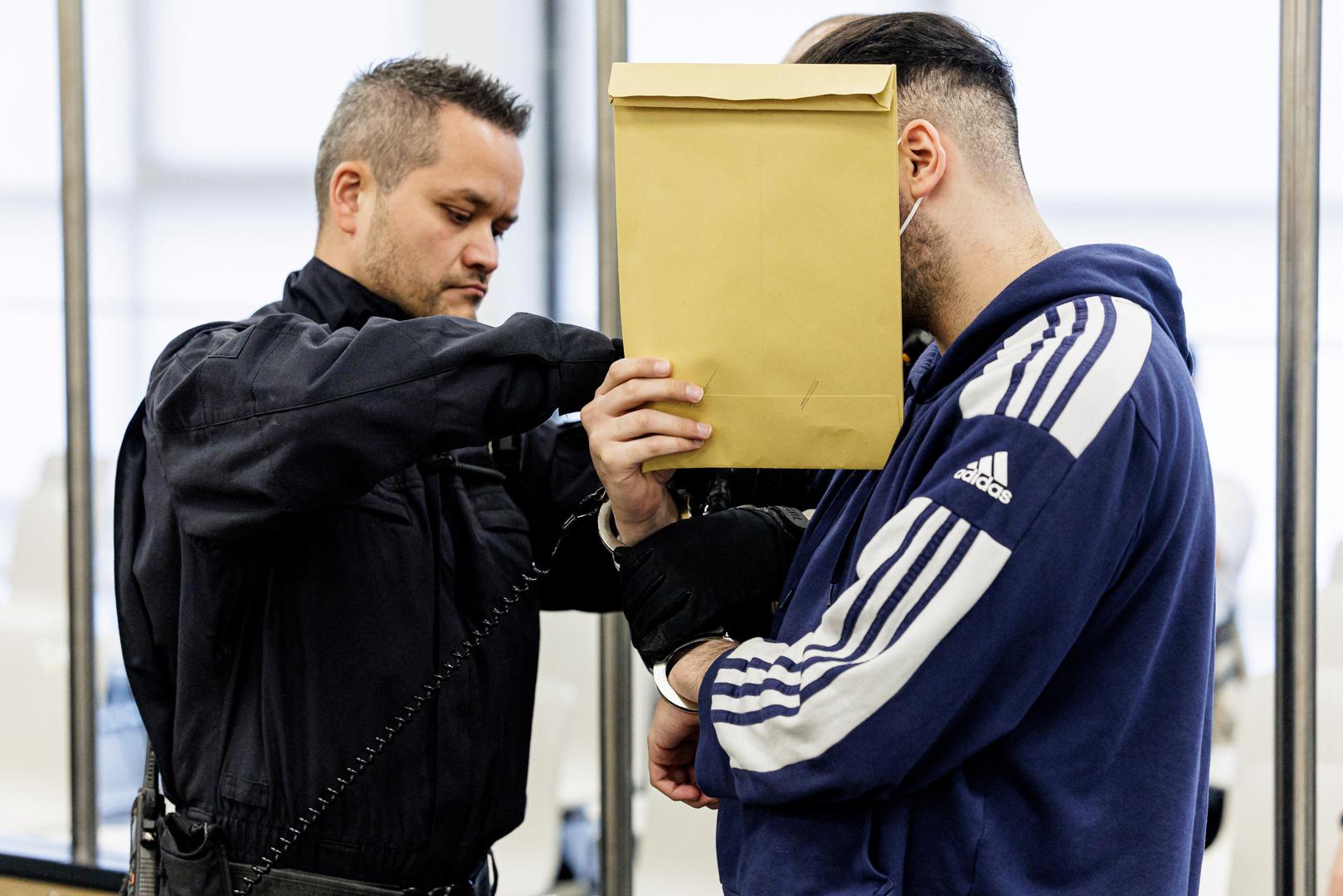 Defendant Abdul Majed R. is led in handcuffs by judicial officers into the courtroom of the Higher Regional Court prior to a hearing in the trial over a November 2019 jewellery heist on the Green Vault (Gruenes Gewoelbe) museum in Dresden's Royal Palace, in Dresden, Germany, March 20, 2023. Jens Schlueter/Pool via REUTERS Photo: POOL/REUTERS