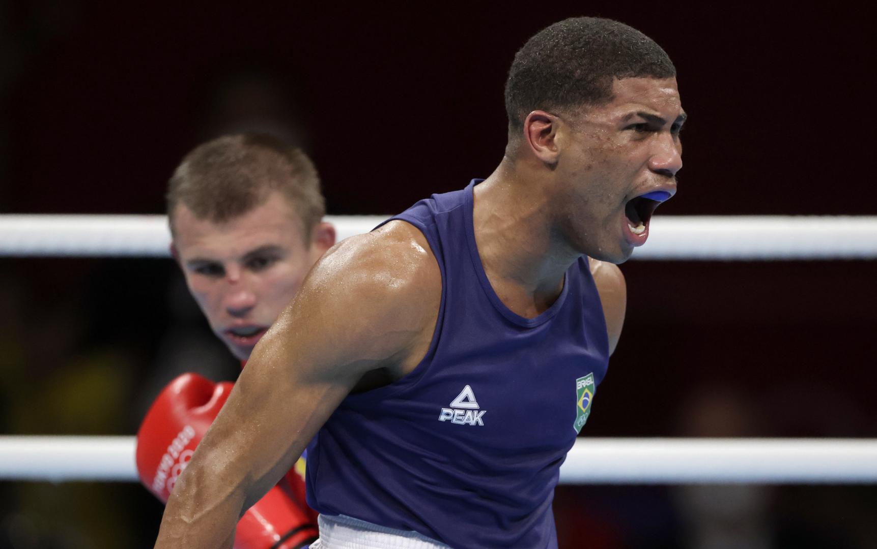 Boxing - Men's Middleweight - Final Tokyo 2020 Olympics - Boxing - Men's Middleweight - Final - Kokugikan Arena - Tokyo, Japan - August 7, 2021. Hebert Sousa of Brazil reacts after knocking down Oleksandr Khyzhniak of Ukraine during their final fight. REUTERS/Ueslei Marcelino UESLEI MARCELINO