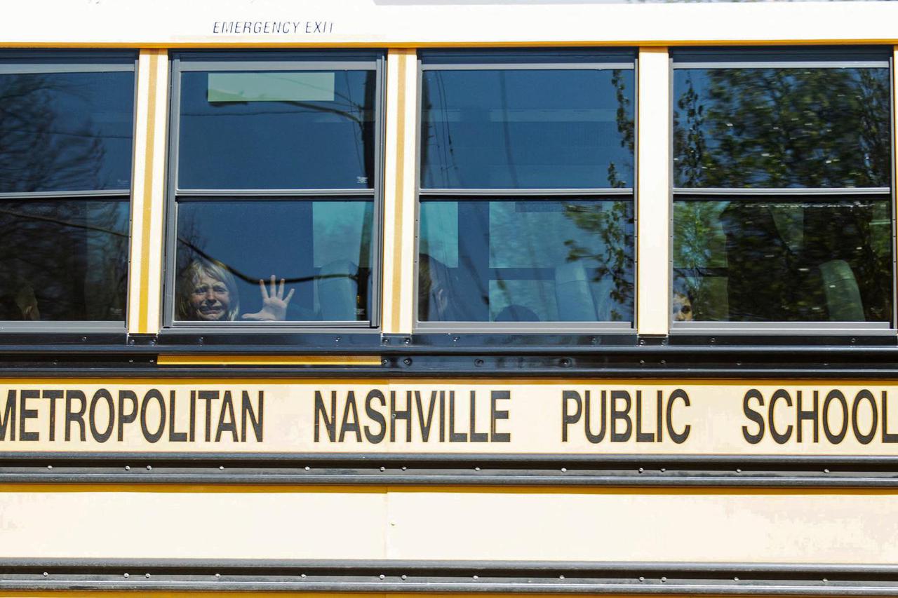 A child weeps while on the bus leaving The Covenant School, following a mass shooting in Nashville