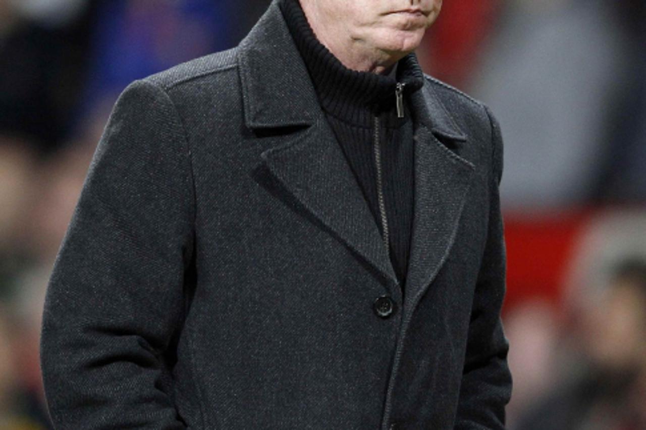 'Manchester United\'s coach Alex Ferguson walks off after their Europa League second leg round of 32 soccer match against Ajax at Old Trafford in Manchester, northern England, February 23, 2012. REUTE