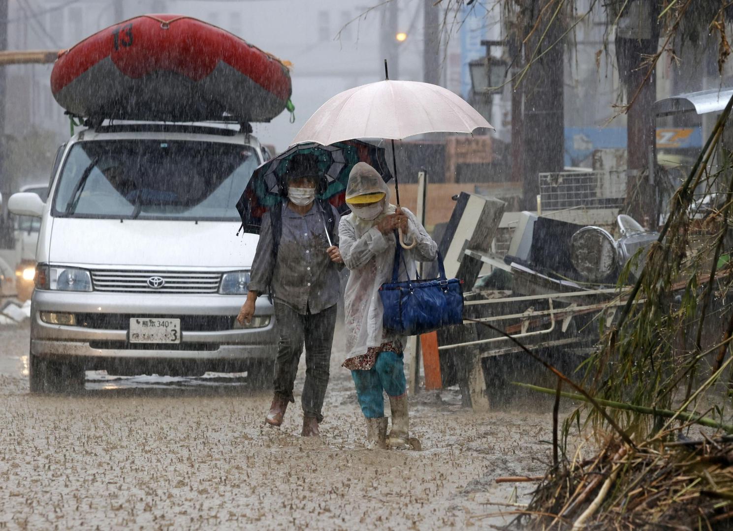 People walk in heavy rain in the flood-ravaged city of Hitoyoshi in Kumamoto Prefecture, southwestern Japan, on July 7, 2020. (Kyodo)
==Kyodo
 Photo via Newscom Newscom/PIXSELL