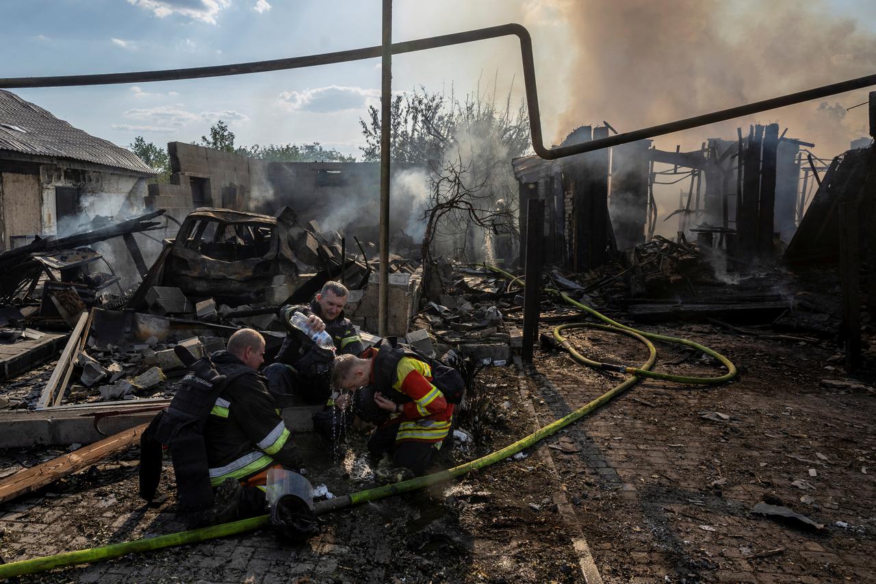 Emergency workers cool off after extinguishing fires following a Russian strike on a residential area in Pokrovsk