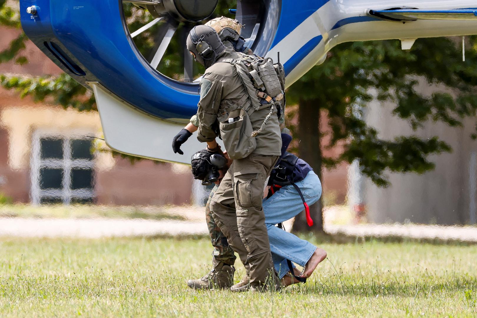 A 26-year-old Syrian man, who is the suspect in custody for a stabbing rampage in the western German city of Solingen in which several individuals were killed, is escorted by police on his way to the Federal Public Prosecutor in Karlsruhe, Germany, August 25, 2024. REUTERS/Heiko Becker Photo: Heiko Becker/REUTERS