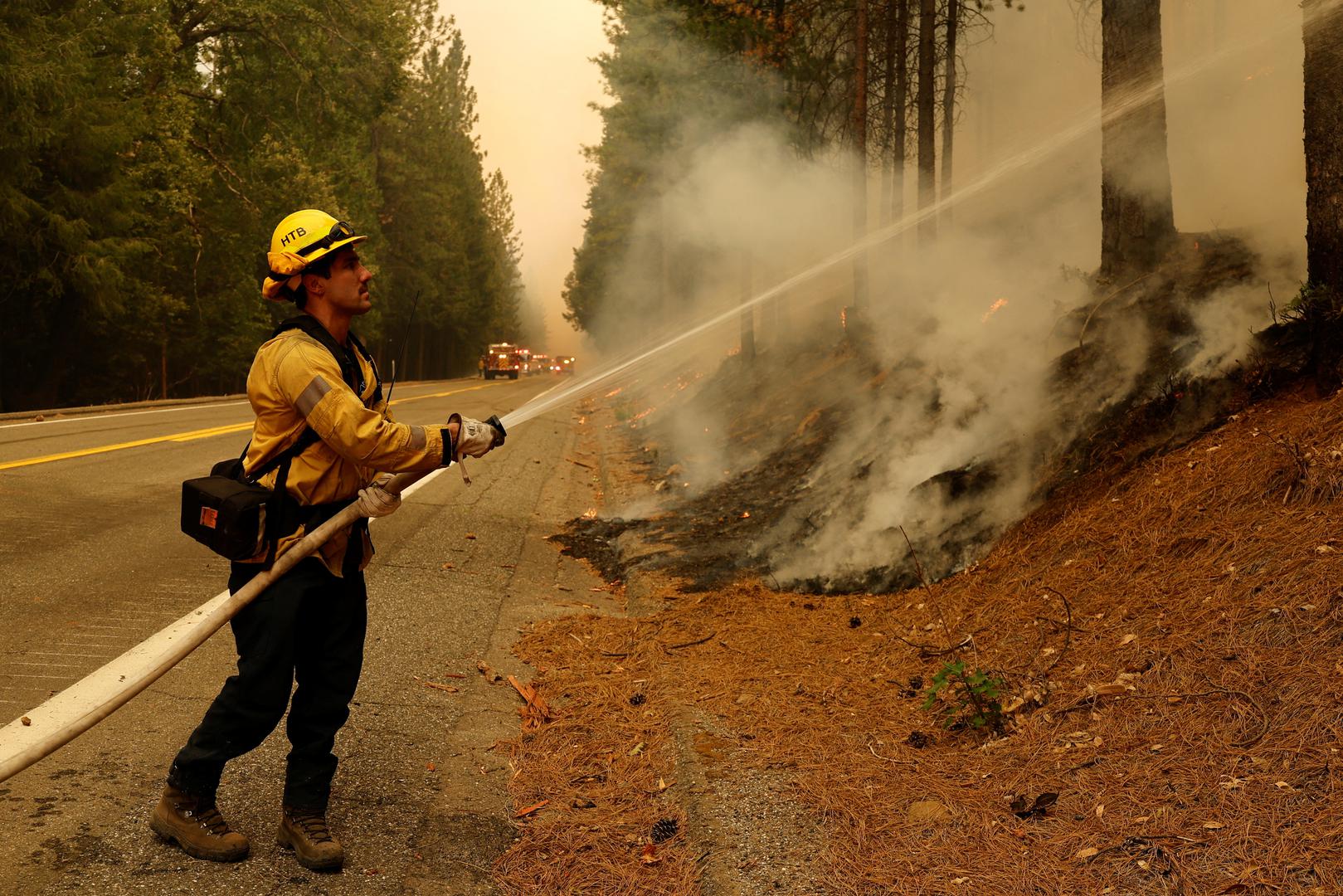 A firefighter works to put out flames along Highway 32 near Forest Ranch, California, U.S. July 26, 2024. REUTERS/Fred Greaves Photo: FRED GREAVES/REUTERS