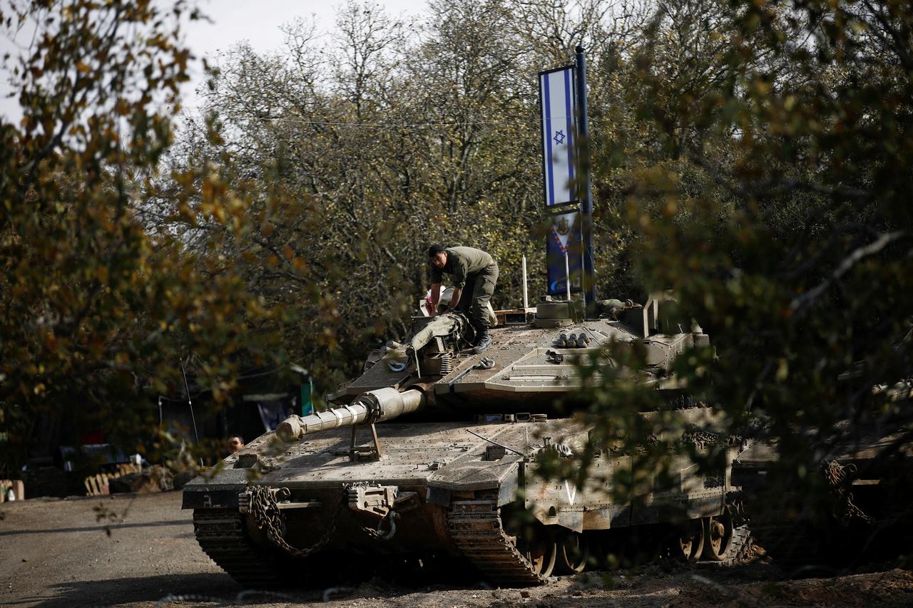 Israeli soldiers stand guard near the ceasefire line between Syria and the Israeli-occupied Golan Heights