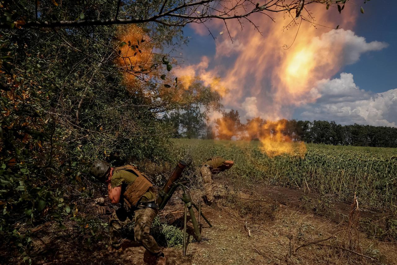 Ukrainian servicemen fire a mortar on a front line in Donetsk region