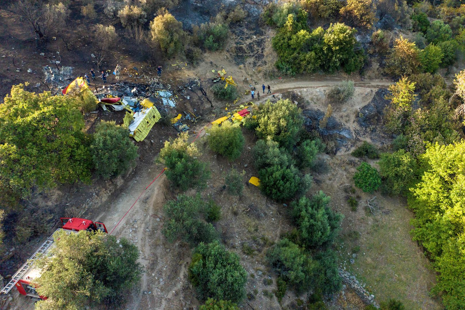 Rescuers operate at the crash site of a firefighting plane that crashed after a water drop as a wildfire burns near the village of Platanistos, on the island of Evia, Greece, July 25, 2023. REUTERS/Stelios Misinas REFILE - CORRECTING NAME OF THE ISLAND from EVIL TO EVIA Photo: STELIOS MISINAS/REUTERS