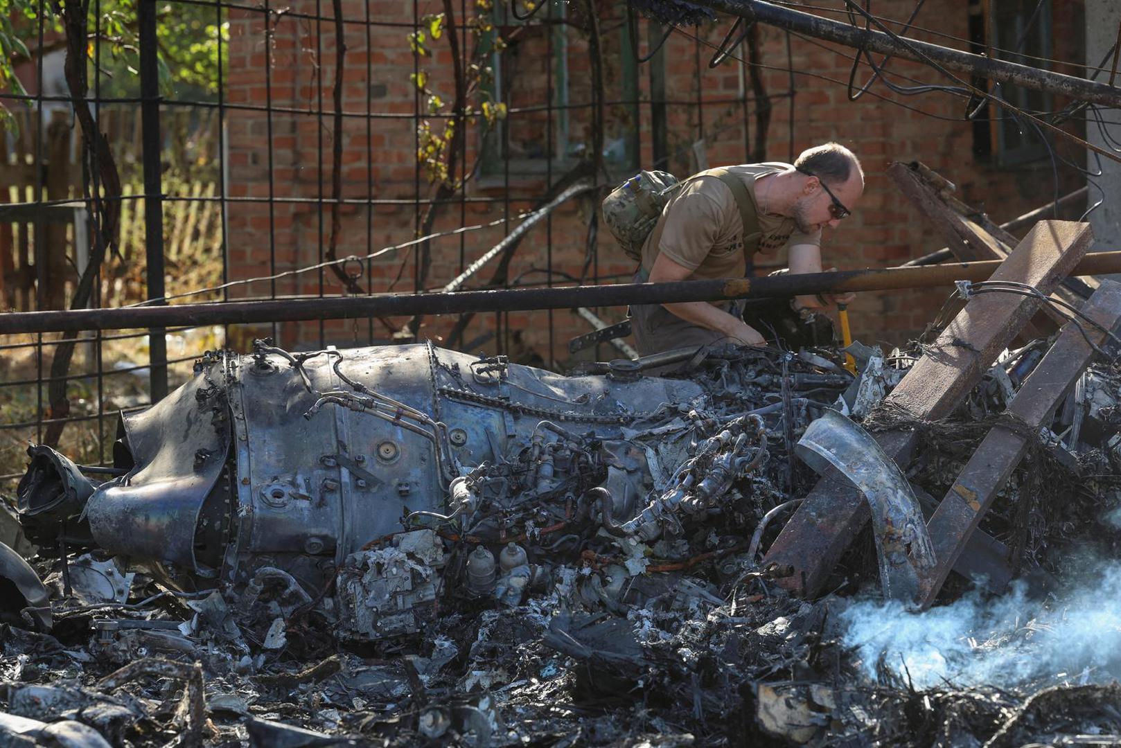 A Ukrainian service member inspects parts of a Russian aerial vehicle, which local authorities assume to be a newest heavy unmanned aerial vehicle S-70 Okhotnik (Hunter) or variation of Sukhoi fighting jet, is seen in residential area of the town of Kostintynivka after it was shot down, amid Russia's attack on Ukraine, in Donetsk region, Ukraine October 5, 2024.  Radio Free Europe/Radio Liberty/Serhii Nuzhnenko via REUTERS    THIS IMAGE HAS BEEN SUPPLIED BY A THIRD PARTY Photo: RFE/RL/SERHII NUZHNENKO/REUTERS