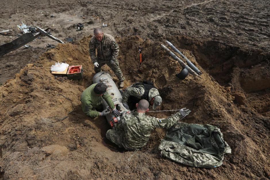 Ukrainian military sappers prepare to deactivate unguided missiles found at the site of a Russian Mi-8 helicopter crash