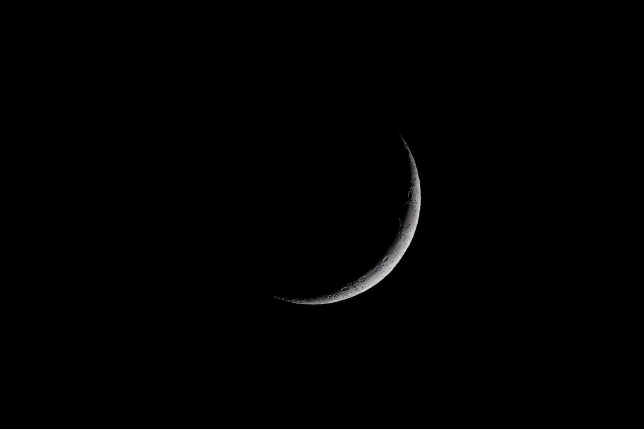 FILE PHOTO: A waxing crescent moon is seen during the International Moon Day