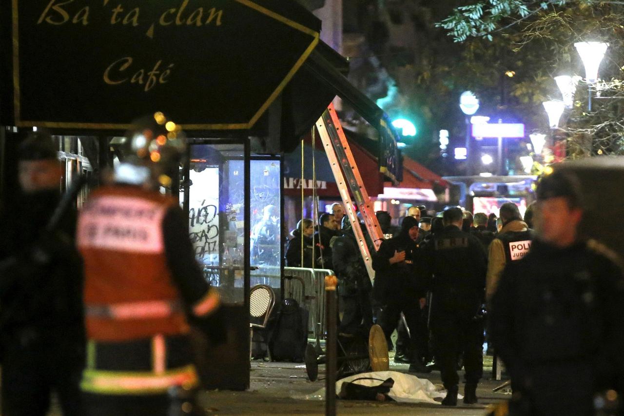 FILE PHOTO: The body of a victim is seen covered, along the sidewalk outside a cafe at the Bataclan concert hall following fatal shootings in Paris