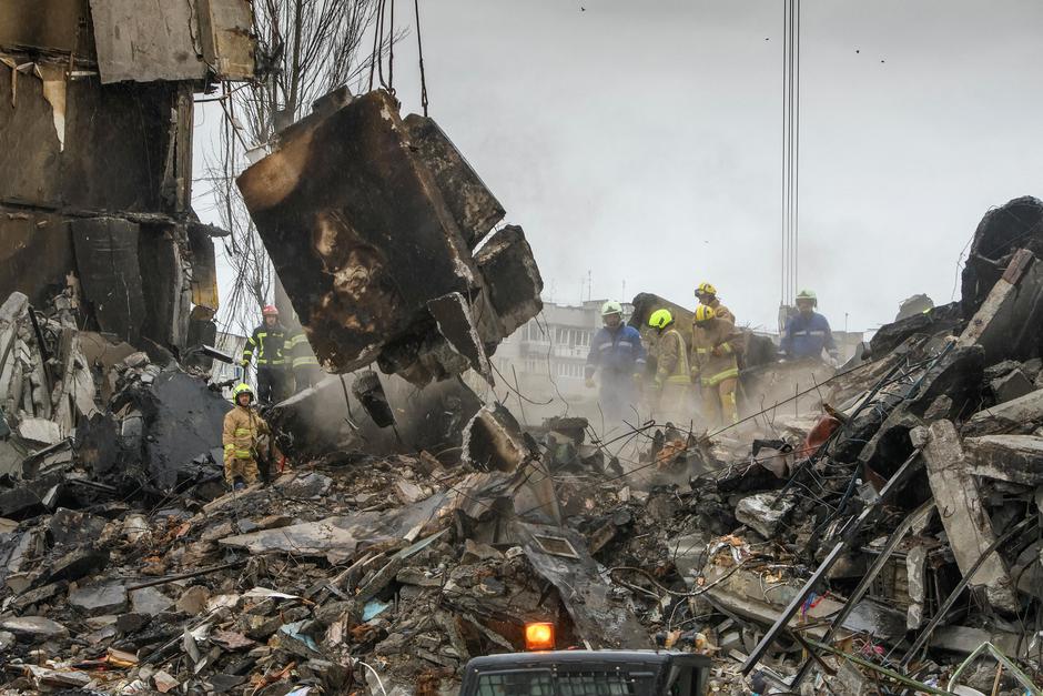 Rescuers remove debris of a residential building destroyed during Russia’s invasion in the town of Borodianka