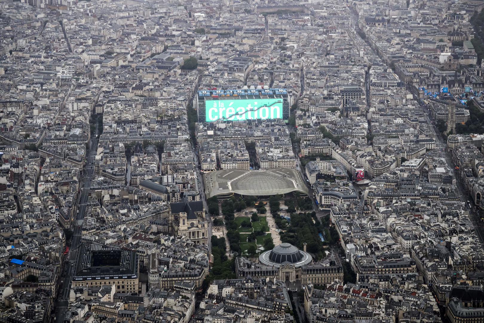 Paris 2024 Olympics - Opening Ceremony - Paris, France - July 26, 2024. A photograph taken from a helicopter shows an aerial view of the Centre Pompidou museum with a screen reading "For the creation" during the opening ceremony of the Paris 2024 Olympic Games in Paris.     LIONEL BONAVENTURE/Pool via REUTERS Photo: LIONEL BONAVENTURE/REUTERS