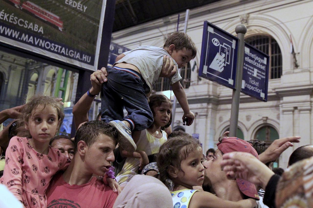 Migrants jostle for positions to board a train as ticket control rules now mandate each passenger to have allocated seats on trains bound for the West from Budapest, Hungary, on August 31, 2015. Austrian authorities toughened controls along the country's 