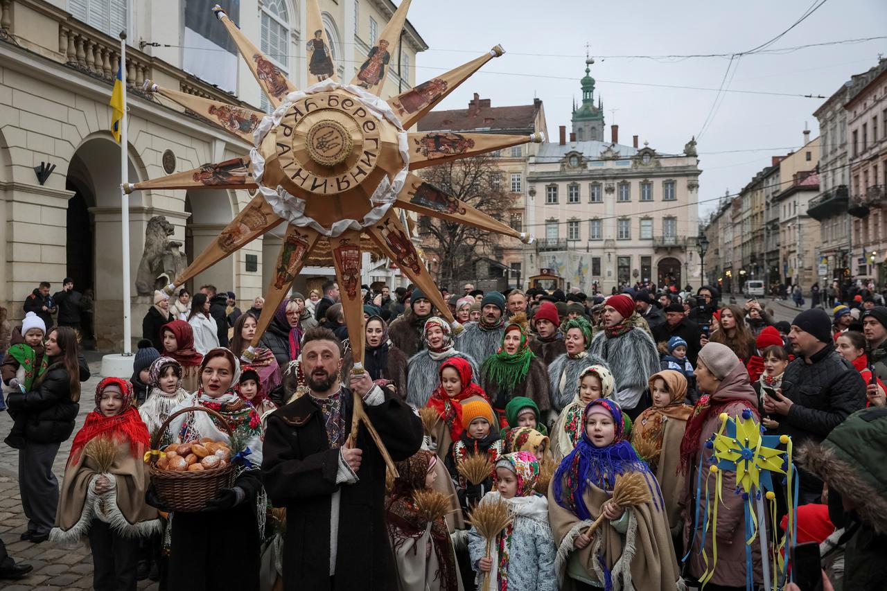 People dressed in traditional Ukrainian costumes attend a Christmas celebration in Lviv