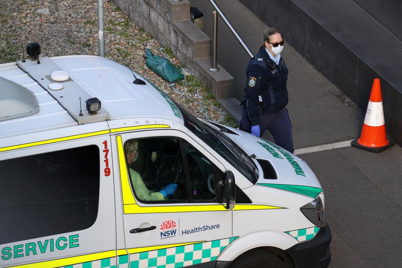 FILE PHOTO: A police officer watches an entrance to a quarantine hotel in Sydney