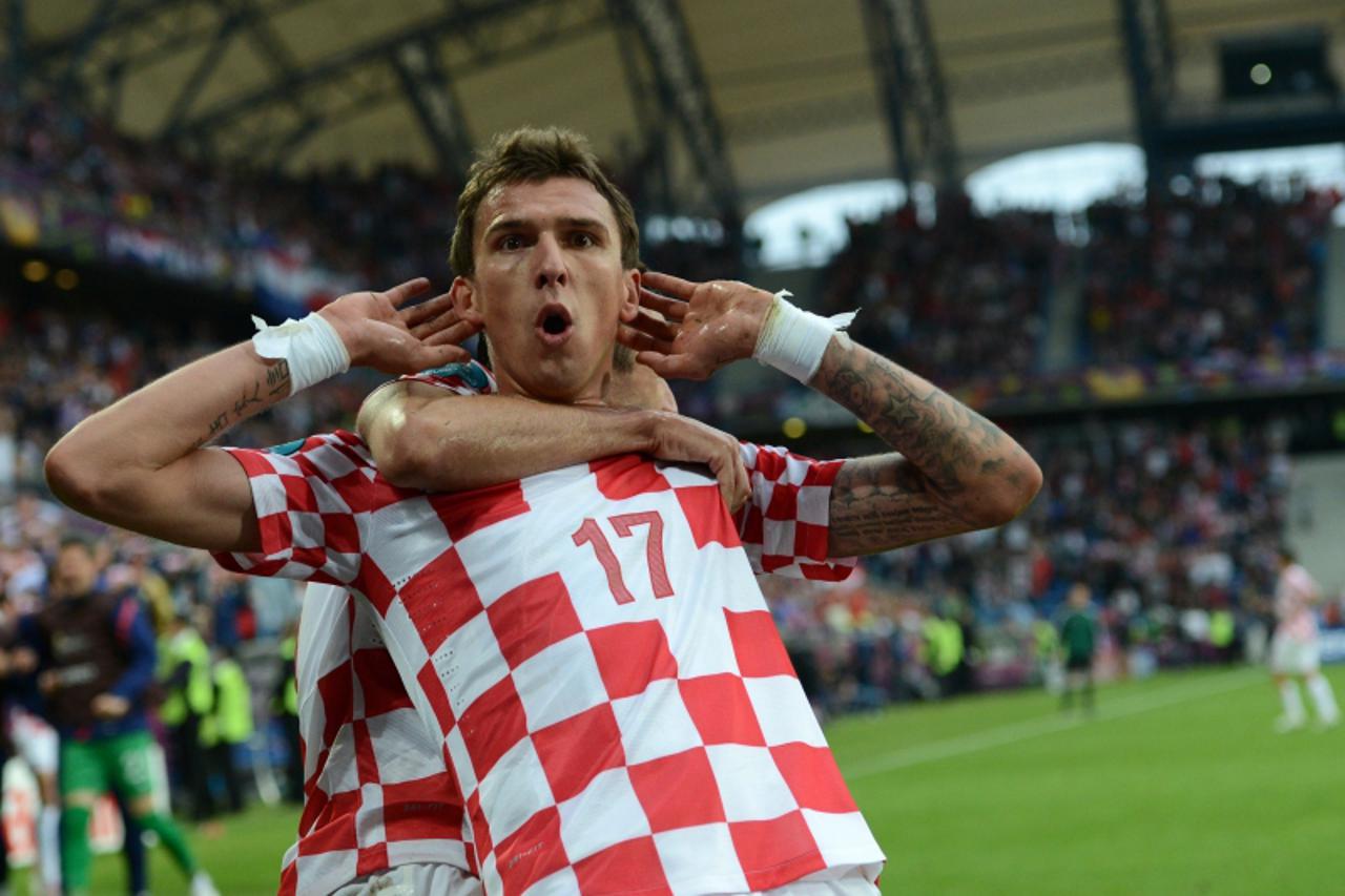 'Croatian forward Mario Mandzukic celebrates after scoring a goal during the Euro 2012 championships football match Italy vs Croatia on June 14, 2012 at the Municipal Stadium in Poznan. AFP PHOTO / FR