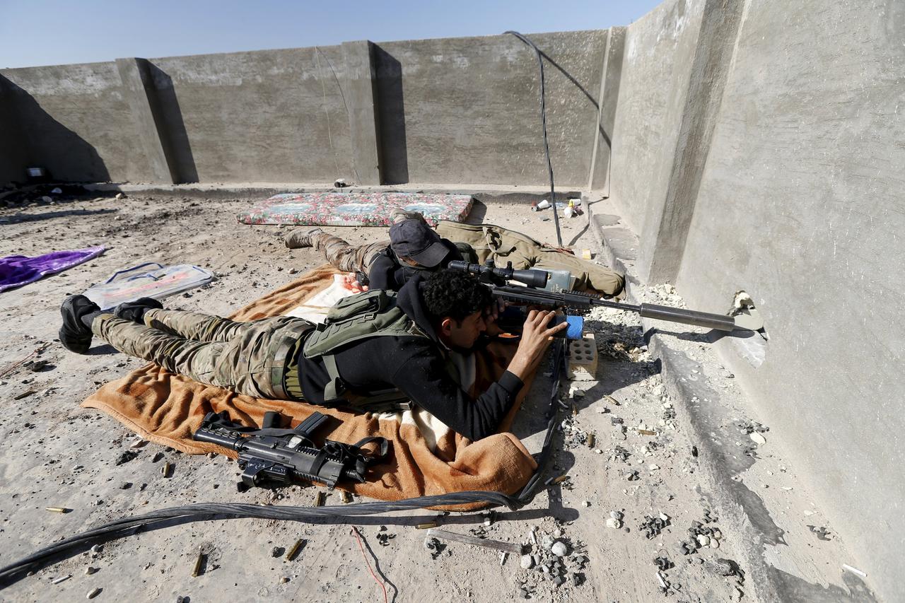 An Iraqi security forces sniper looks through the scope of his rifle as he guards in the city of Ramadi, January 16, 2016. Baghdad and Washington have touted Ramadi as the first major success for Iraq's U.S.-backed army since it collapsed in the face of I