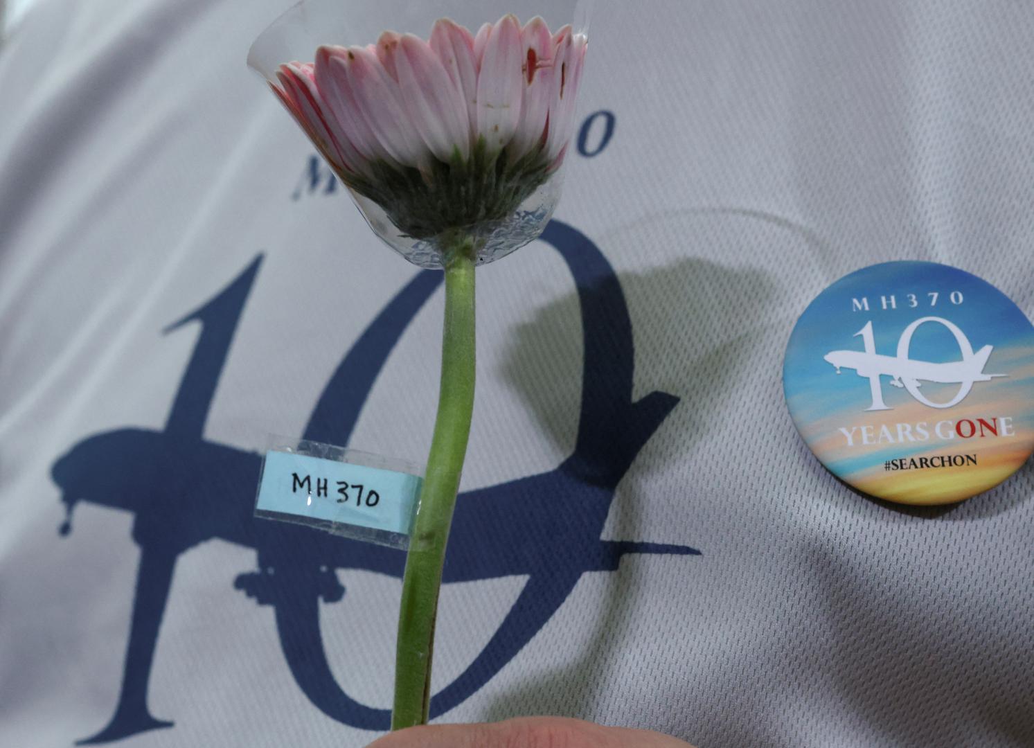 A family member of the missing Malaysia Airlines flight MH370 holds a flower during a remembrance event marking the 10th anniversary of its disappearance, in Subang Jaya, Malaysia March 3, 2024. REUTERS/Hasnoor Hussain Photo: HASNOOR HUSSAIN/REUTERS