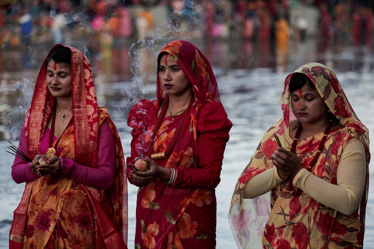 Hindu devotees worship the Sun god during the Hindu religious festival of Chhath, in Kathmandu