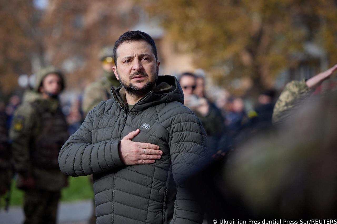 Ukraine's President Volodymyr Zelenskiy sings the national anthem during his visit in Kherson