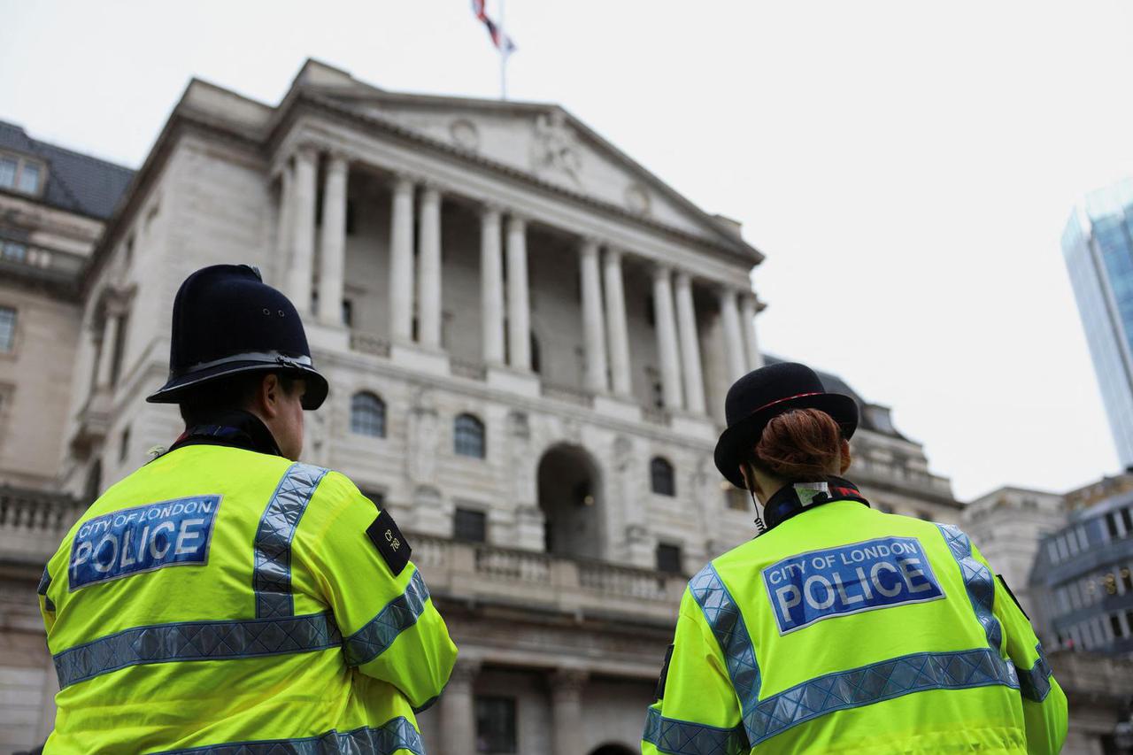 Police stand in front of the Bank of England as Extinction Rebellion activists protest, in London