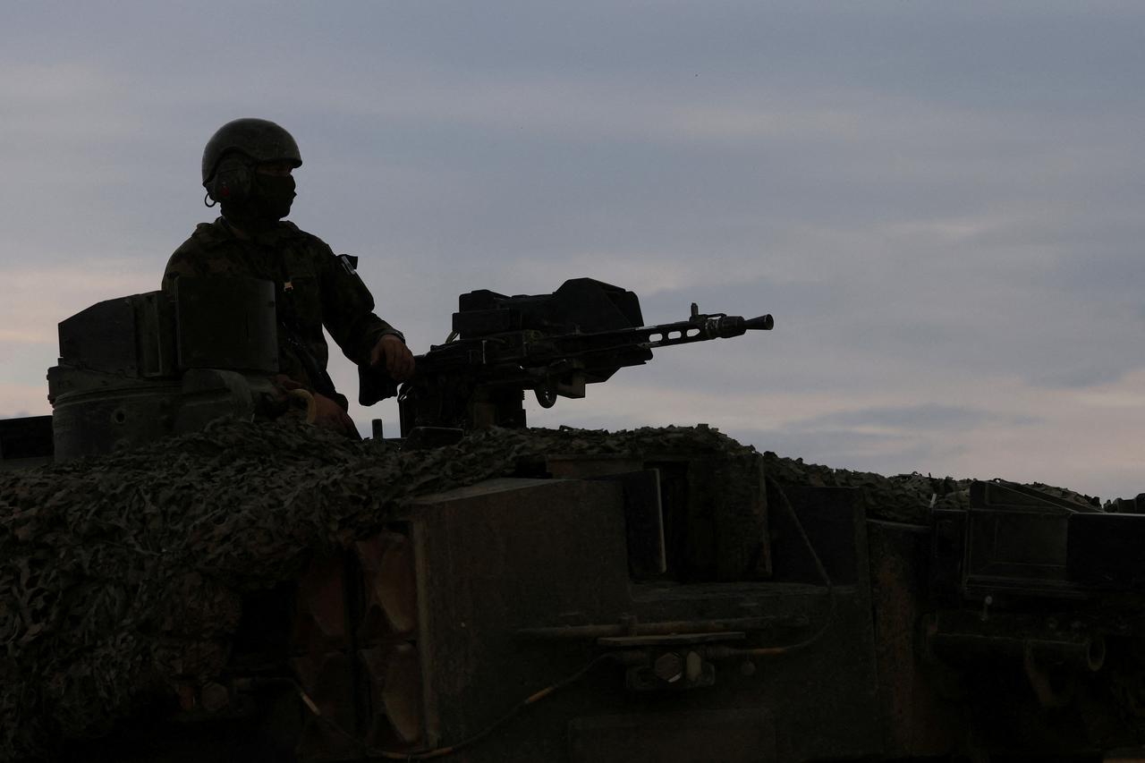 FILE PHOTO: A recruit of the Swiss army Tank School 21 performs an attack exercise with the Leopard 2 tank in Bure