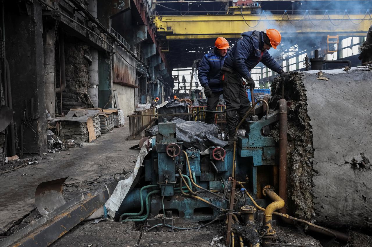 Workers fix a thermal power plant damaged by a Russian missile strike at an undisclosed location in Ukraine