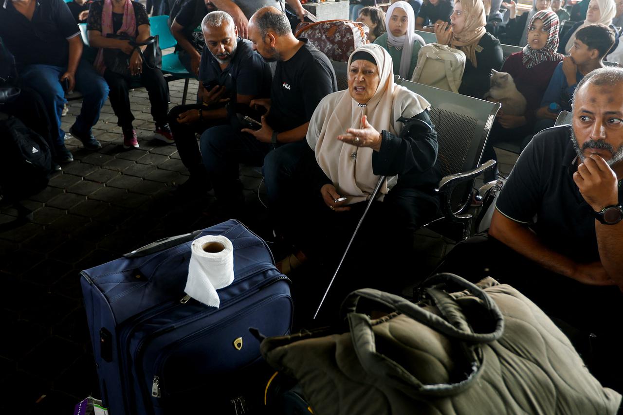 Palestinians check the damage of an ambulance convoy