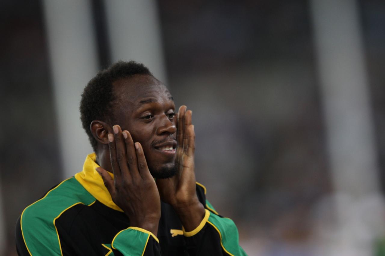 'Jamaica\'s Usain Bolt reacts during the award ceremony for the men\'s 4x100 metres relay event at the International Association of Athletics Federations (IAAF) World Championships in Daegu on Septemb