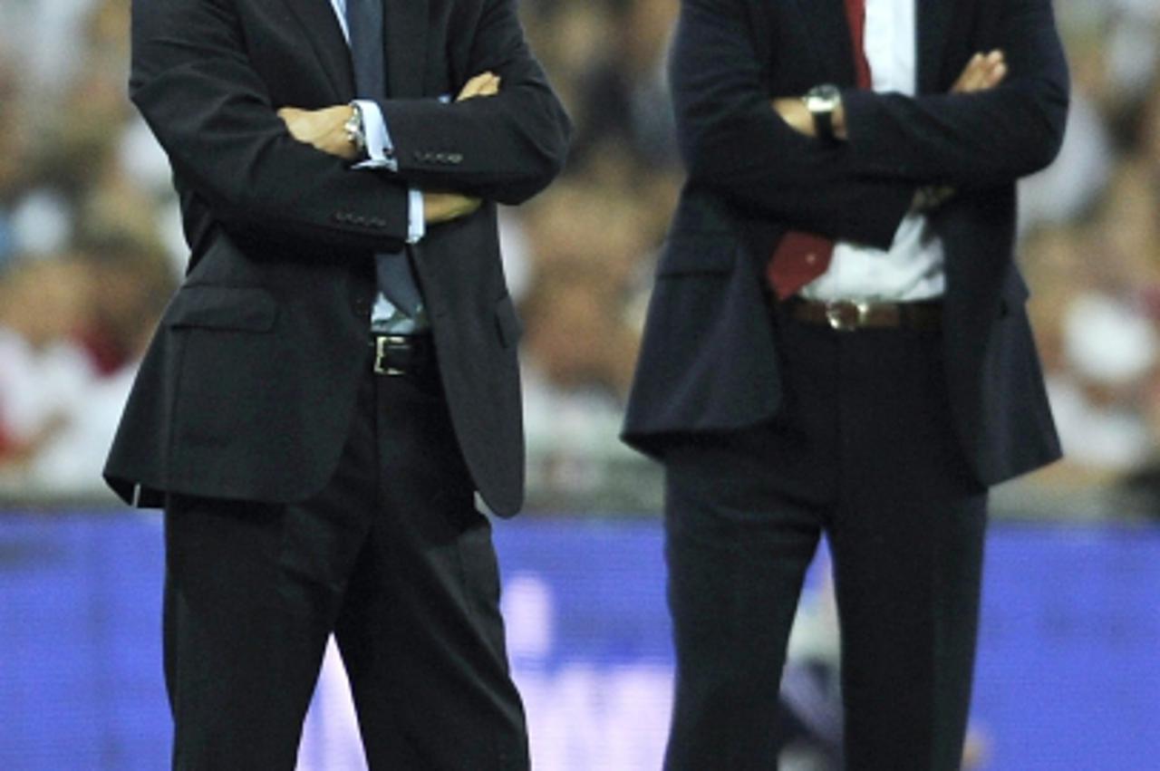 'England Manager Fabio Capello (L) shouts instructions to his players alongside Croatia\'s Manager Slaven Bilic (R) during the Group Six FIFA World Cup 2010 qualifier between England and Croatia at We