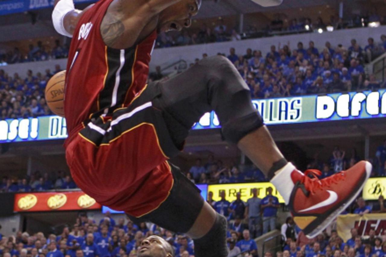 'Miami Heat's Chris Bosh (above) dunks over Dallas Mavericks' DeShawn Stevenson during Game 3 of the NBA Finals basketball series in Dallas, June 5, 2011. REUTERS/Lucy Nicholson (UNITED STATES  - Ta