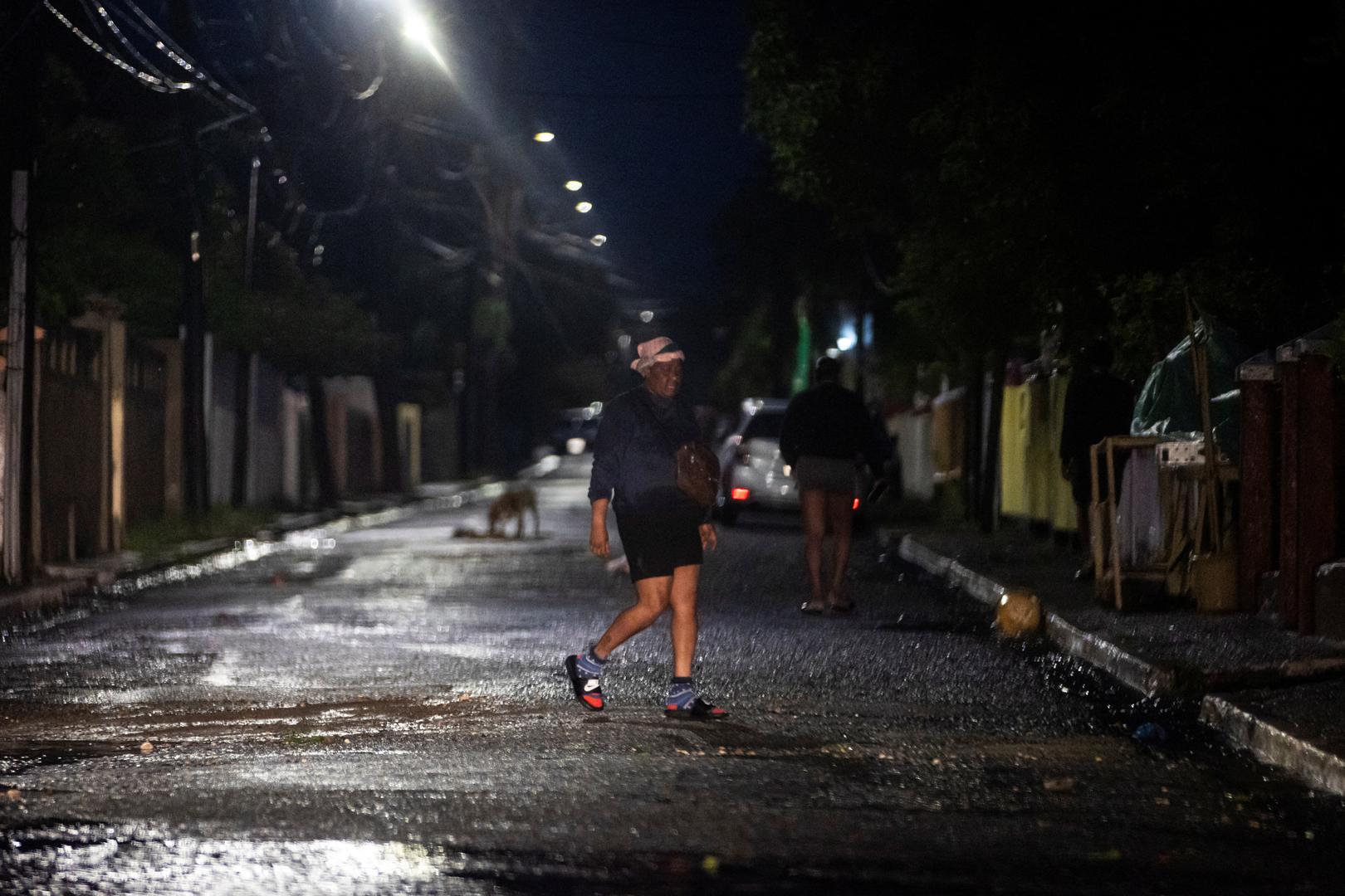 A man walks in the rain as Hurricane Beryl hits the southern coast of the island, in Kingston, Jamaica, July 3, 2024. REUTERS/Marco Bello Photo: MARCO BELLO/REUTERS