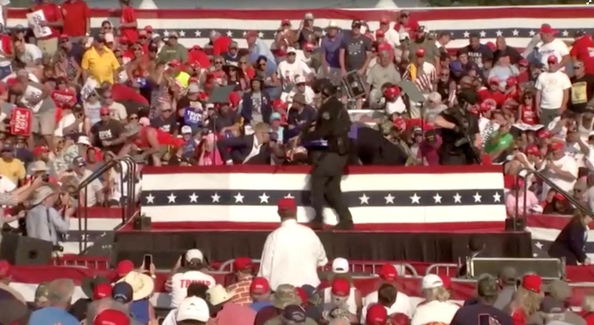 People crouch during a rally for Republican presidential candidate and former U.S. President Donald Trump after gunfire rang out at the Butler Farm Show in Butler, Pennsylvania, U.S., July 13, 2024, in this screen grab taken from a video. ABC/US Network Pool/ Handout via REUTERS ATTENTION EDITORS - THIS PICTURE WAS PROVIDED BY A THIRD PARTY. NO RESALES. NO ARCHIVES. MANDATORY CREDIT. Photo: ABC/US Network Pool/REUTERS