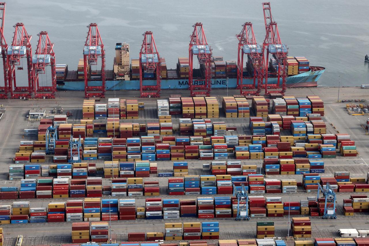 FILE PHOTO: Shipping containers are unloaded from a ship at a container terminal at the Port of Long Beach-Port of Los Angeles complex