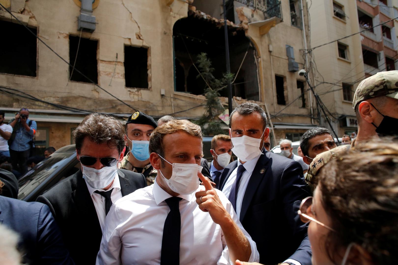 French President Emmanuel Macron visits devastated streets of Beirut French President Emmanuel Macron talks to a resident as he visits a devastated street of Beirut, Lebanon August 6, 2020. Thibault Camus/Pool via REUTERS POOL