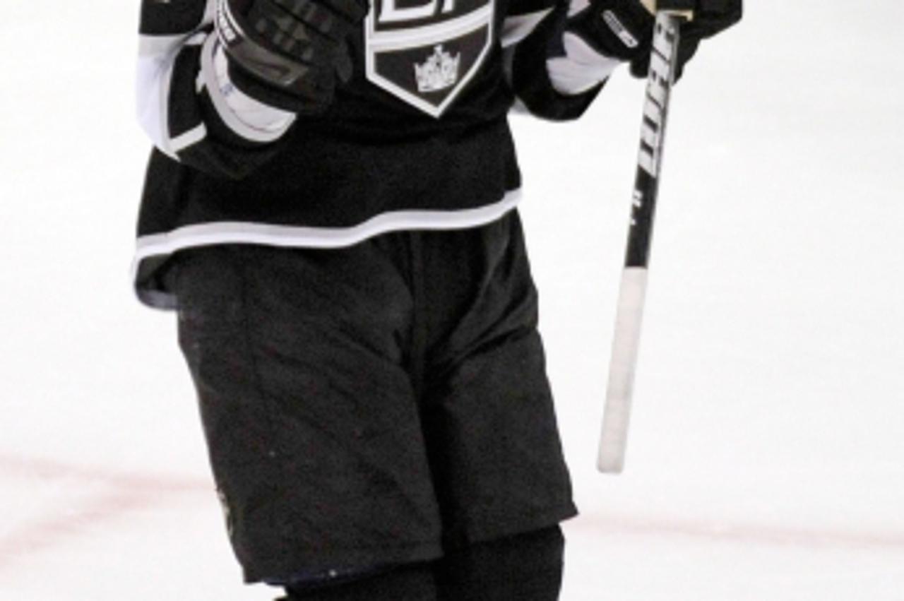 'LOS ANGELES, CA - OCTOBER 06: Anze Kopitar #11 of the Los Angeles Kings celebrates teammate Davis Drewiske #44 first NHL goal against the San Jose Sharks during the thrid period of the NHL hockey gam