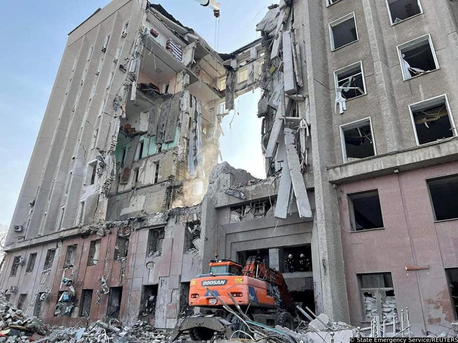 Rescuers work at the site of the regional administration building hit by cruise missiles, in Mykolaiv