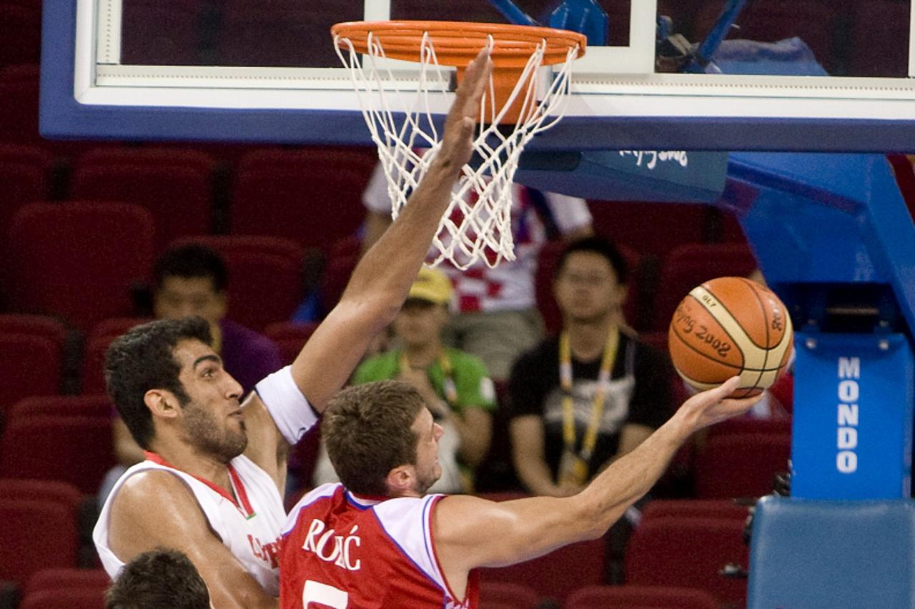 \'Croatia\'s Marin Rozic (R) goes for a lay up against Iran\'s Hamed Ehadadi in their  preliminary round group B basketball match at the Beijing 2008 Olympic Games on August 18, 2008.  Croatia won 91-