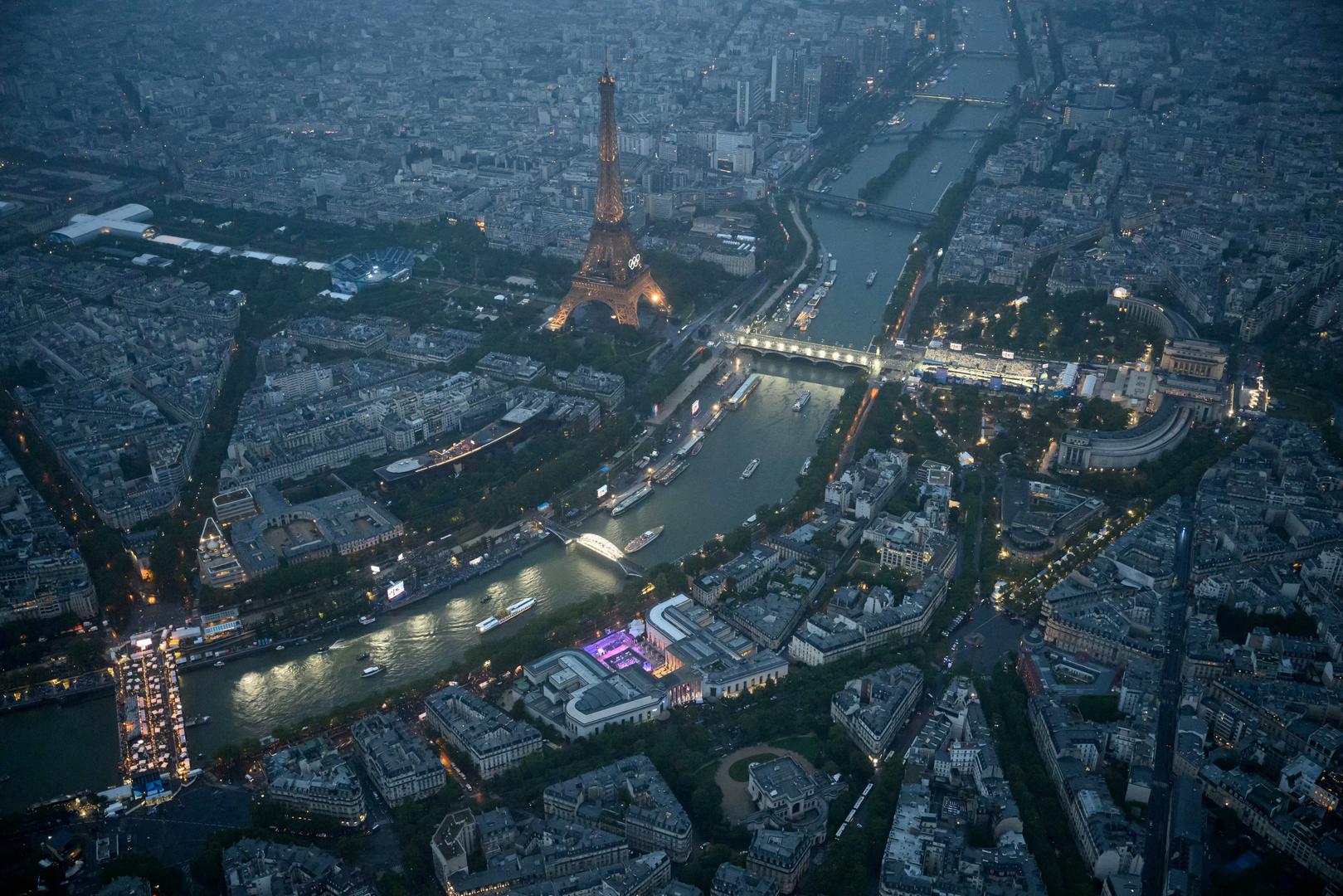 Paris 2024 Olympics - Opening Ceremony - Paris, France - July 26, 2024. An aerial view of delegation boats navigating down the Seine river near the Eiffel Tower during the opening ceremony of the Paris 2024 Olympic Games.     LIONEL BONAVENTURE/Pool via REUTERS Photo: LIONEL BONAVENTURE/REUTERS