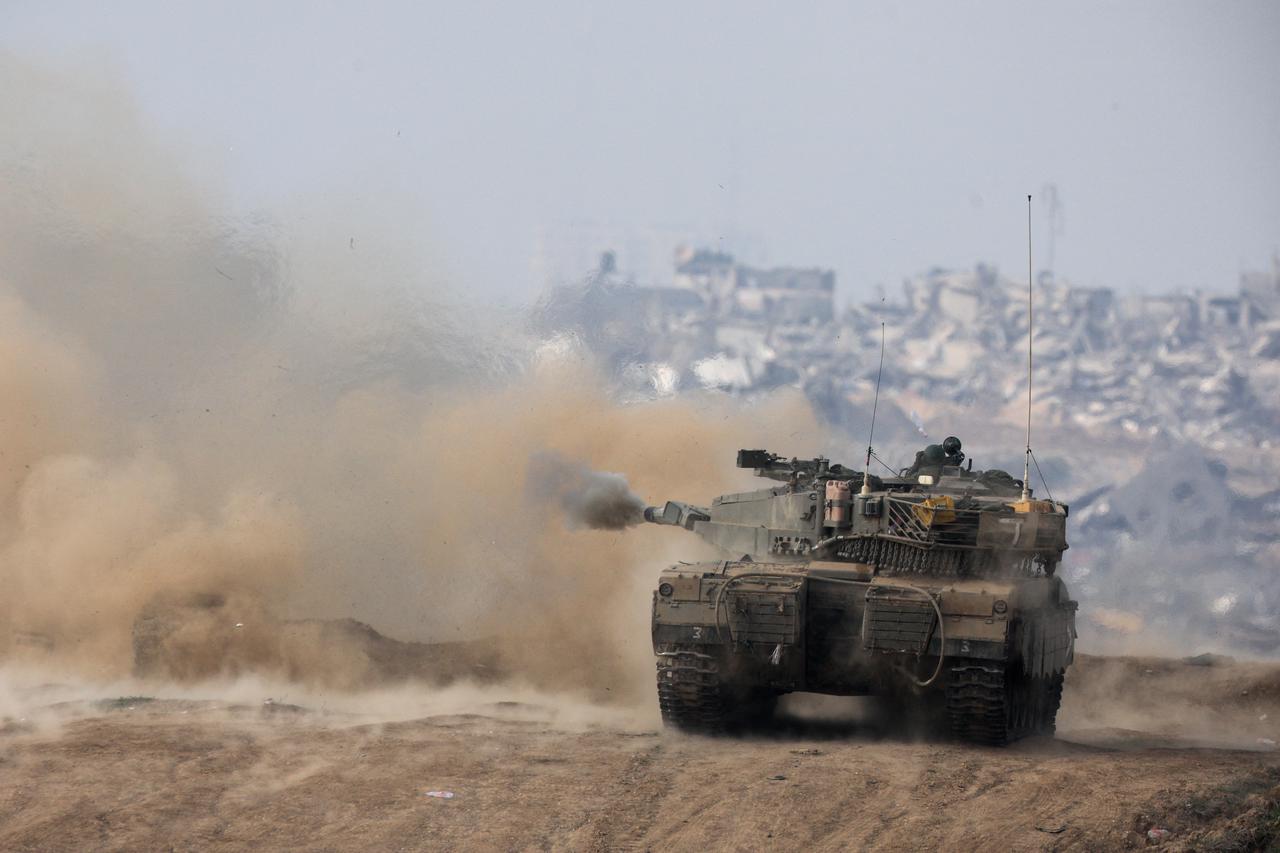 An Israeli tank fires towards Gaza, at the Israel-Gaza border