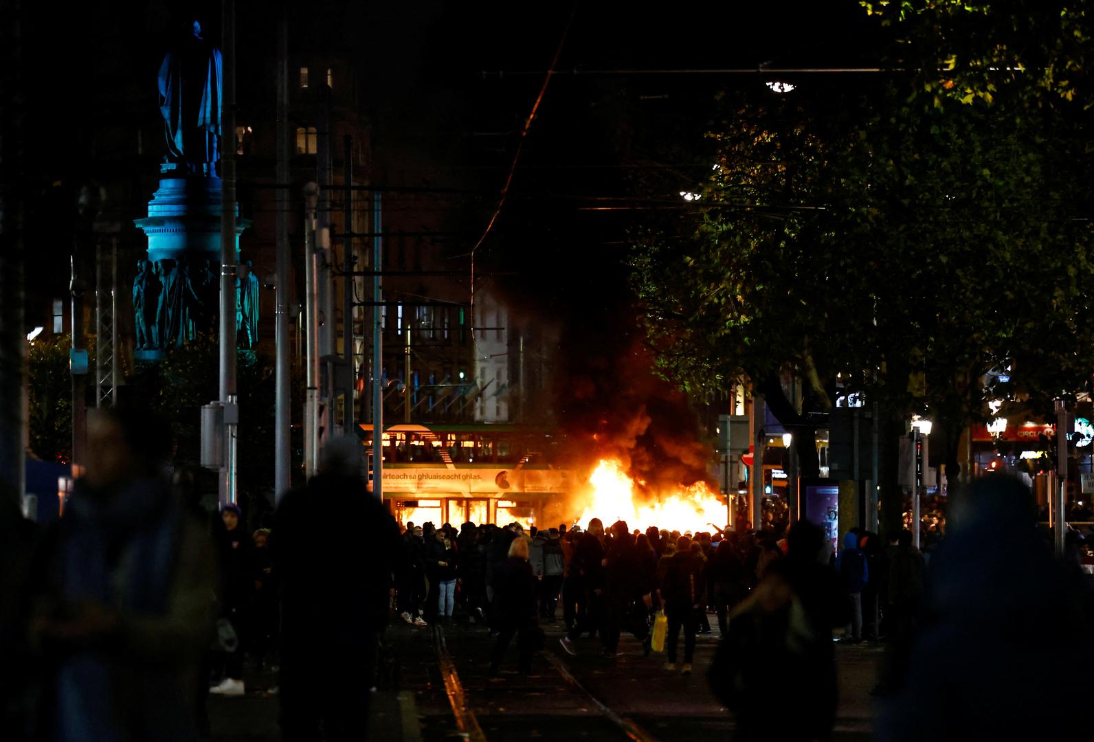 Fire burns as people gather near the scene of a suspected stabbing that left few children injured in Dublin, Ireland, November 23, 2023. REUTERS/Clodagh Kilcoyne Photo: Clodagh Kilcoyne/REUTERS