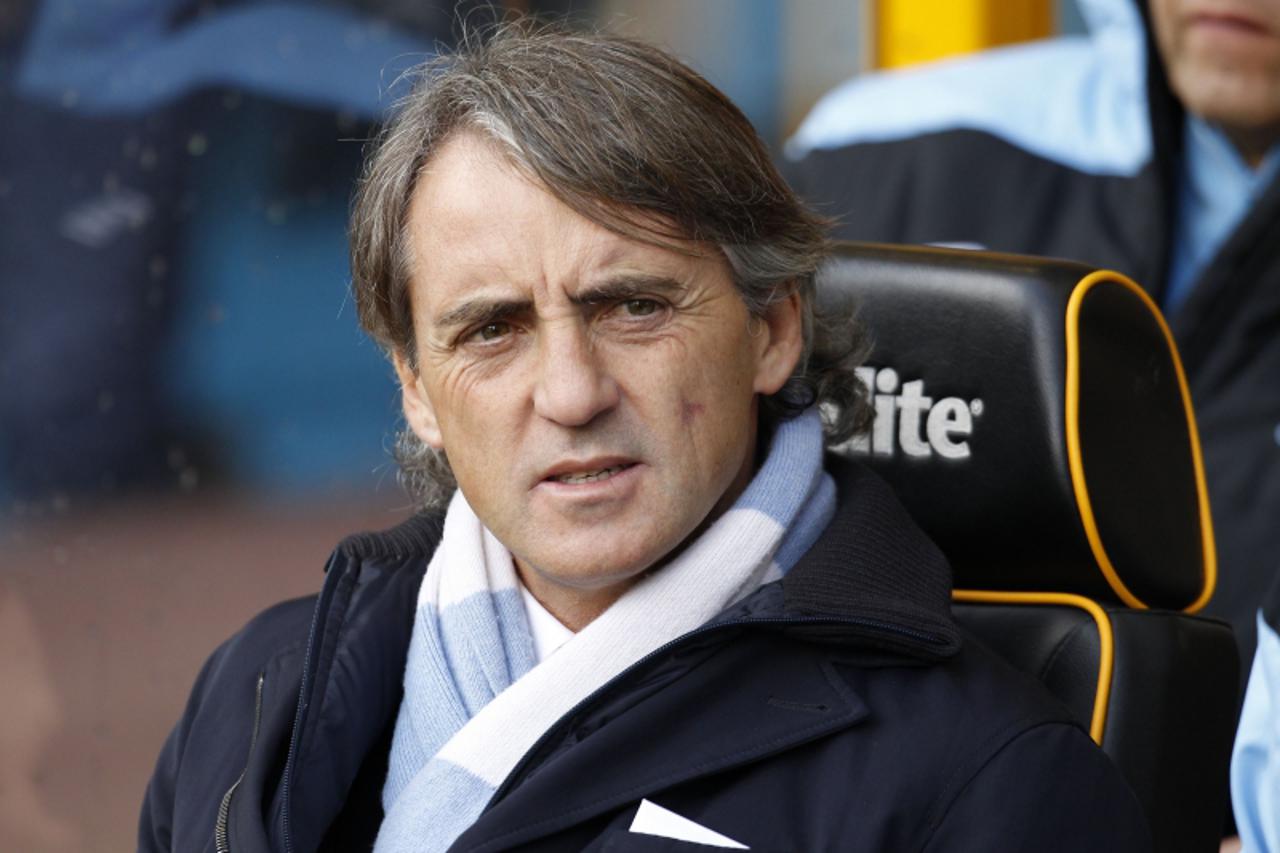 'Manchester City\'s Italian manager Roberto Mancini awaits kick off during an English Premier League football match between Wolverhampton Wanderers and Manchester City at Molineux Stadium in Wolverham