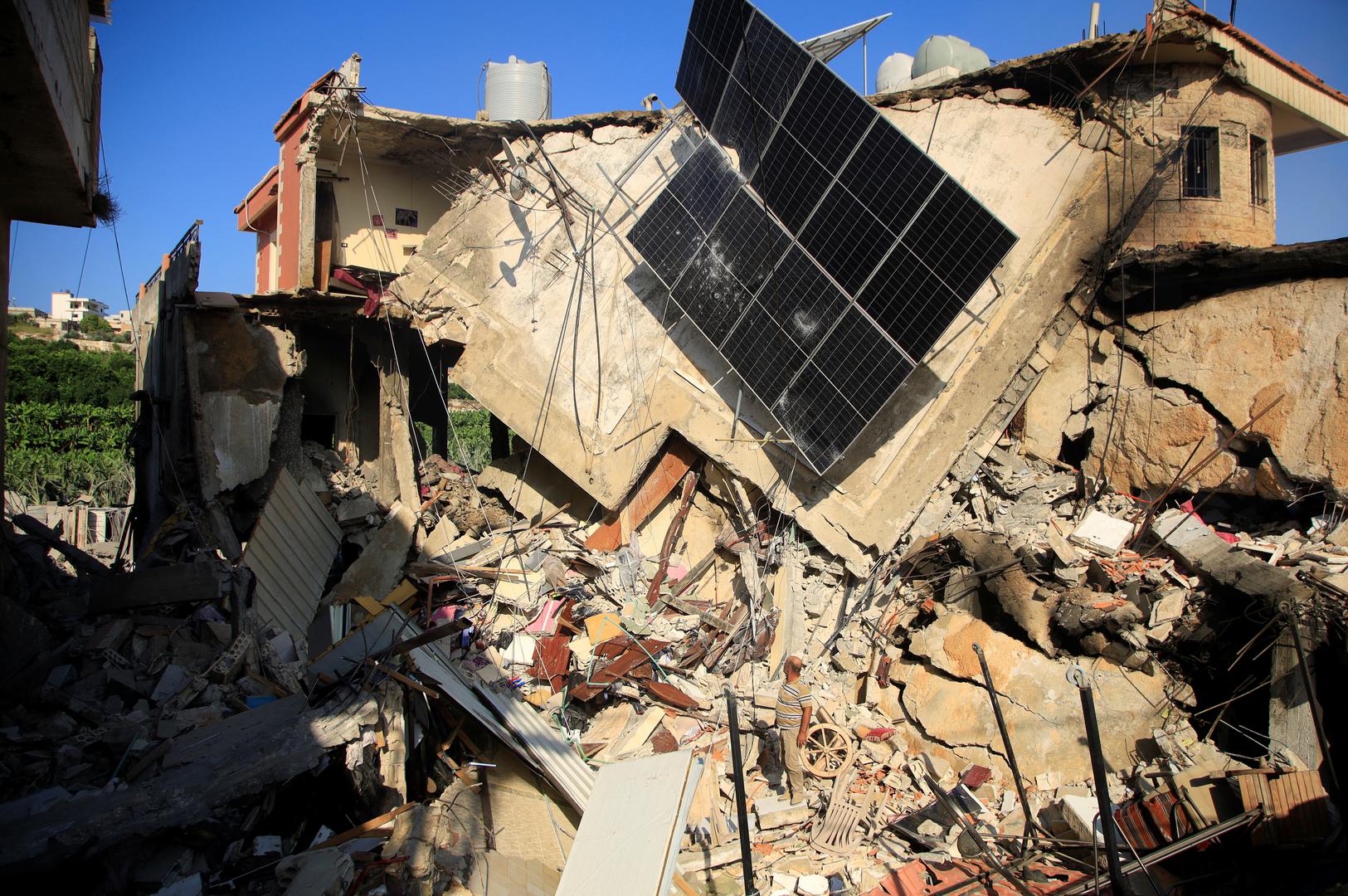 A man stands on the rubble of a damaged building, in the Lebanese southern village of Akbiyeh, amid ongoing cross-border hostilities between Hezbollah and Israeli forces, Lebanon, September 24, 2024. REUTERS/Stringer Photo: Stringer/REUTERS